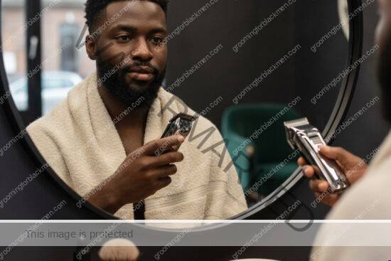 Black man preparing for a barber visit with clean grooming tools