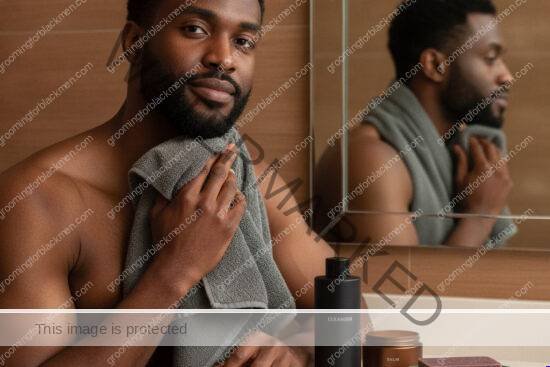 Black man calmly simplifying his post-shave routine after irritation