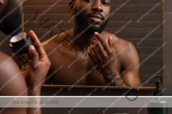 Black man with rich brown skin using a calm grooming routine for ingrown hair care