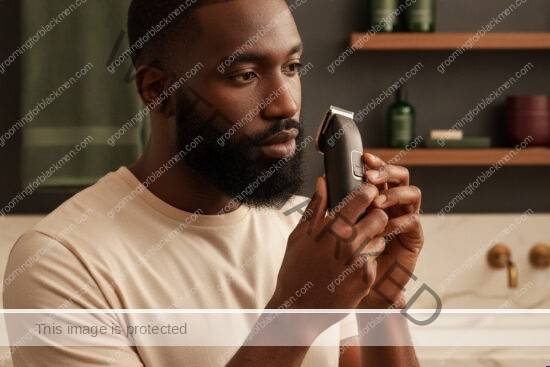 Black man with rich brown skin preparing a clean lineup routine without irritation
