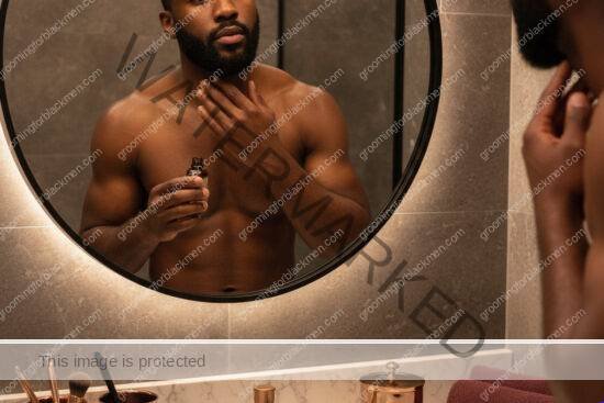 Black man with rich brown skin grooming his neckline with care to reduce neck bumps