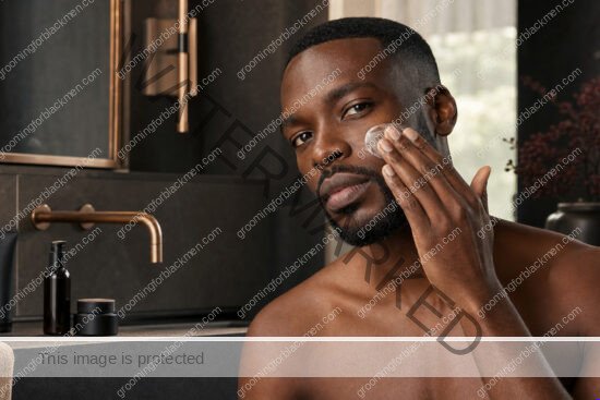 Black man beginning a basic skincare routine Black men simple routine in a premium grooming setting