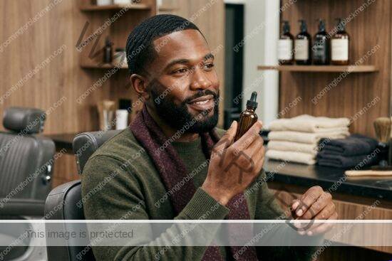 Black man with rich brown skin using amazon basics grooming in a premium grooming setting