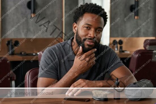 Black man with rich brown skin using travel budget kit in a premium grooming setting