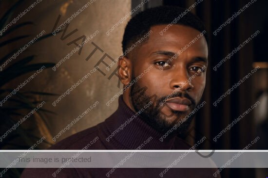 Black man in a premium editorial setting for tinted moisturizer for Black men dark skin
