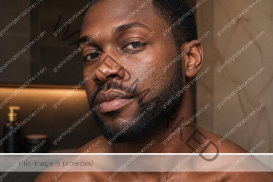 Black man in a premium editorial setting for dry patches on face Black men treatment