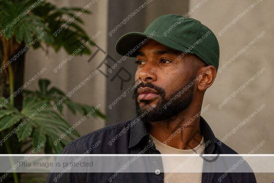 Black man in a premium editorial setting for sunscreen for Black men why necessary